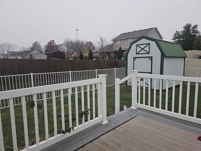 deck featuring a storage unit and a yard