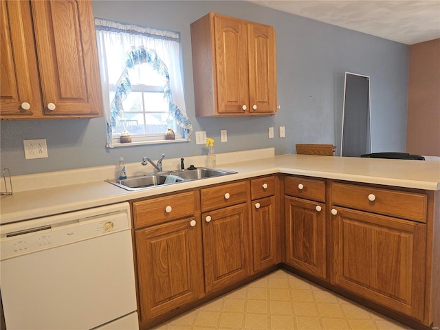 kitchen with dishwasher, kitchen peninsula, and sink