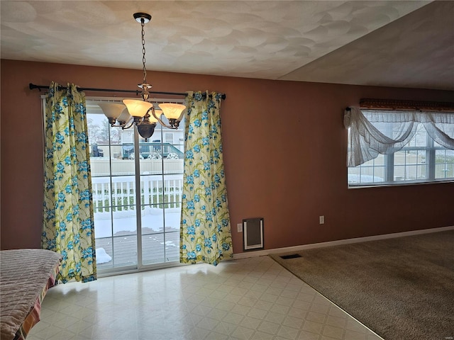 unfurnished dining area with light colored carpet, a wealth of natural light, and a notable chandelier