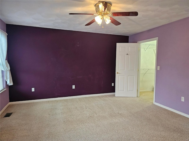 carpeted empty room with ceiling fan