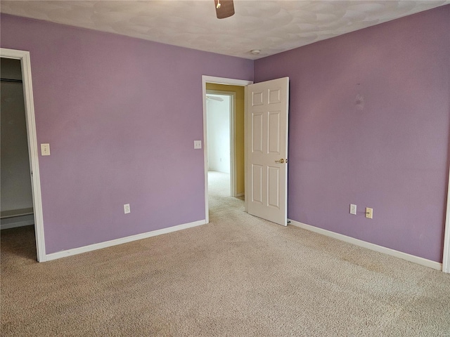 unfurnished bedroom featuring ceiling fan and light carpet