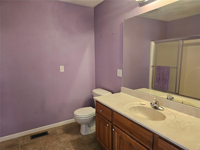 bathroom with tile patterned flooring, vanity, and toilet