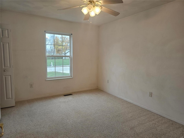 spare room featuring ceiling fan and light colored carpet