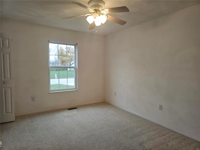 carpeted spare room with ceiling fan