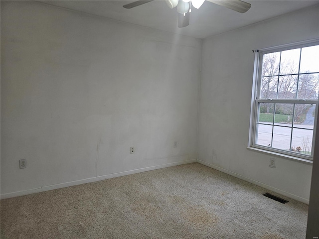 carpeted spare room featuring ceiling fan