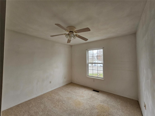 carpeted empty room featuring ceiling fan