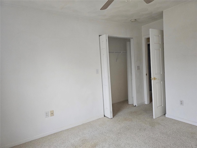 unfurnished bedroom with ceiling fan, a closet, and light colored carpet