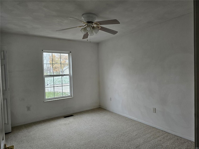 carpeted empty room with ceiling fan