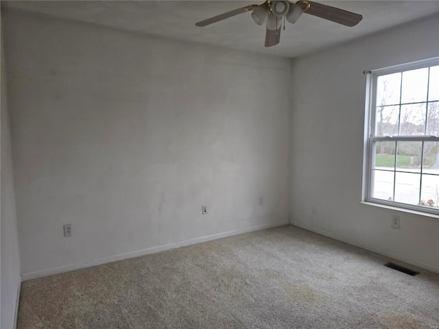 spare room featuring carpet flooring and ceiling fan