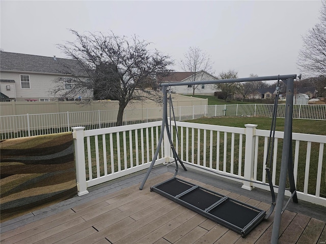 wooden terrace featuring a lawn