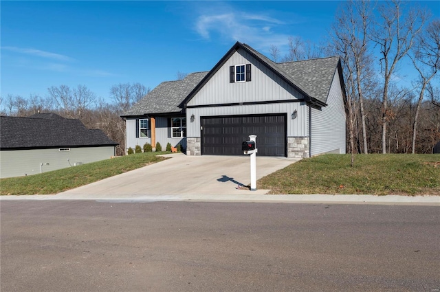 view of front of property with a front yard and a garage