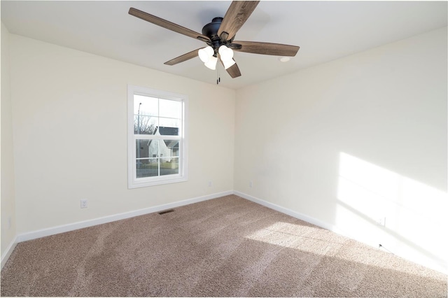 unfurnished room with carpet and ceiling fan