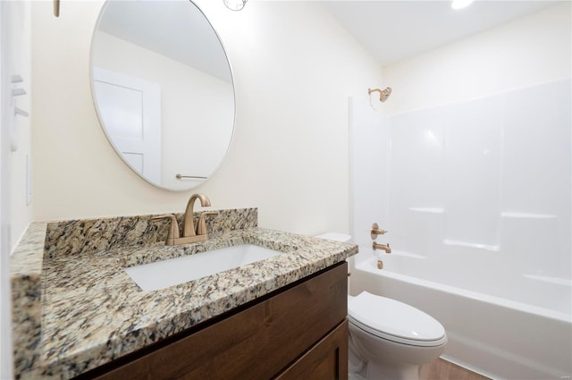 full bathroom featuring washtub / shower combination, wood-type flooring, vanity, and toilet