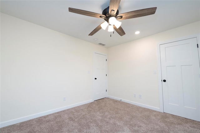 unfurnished room featuring light carpet and ceiling fan