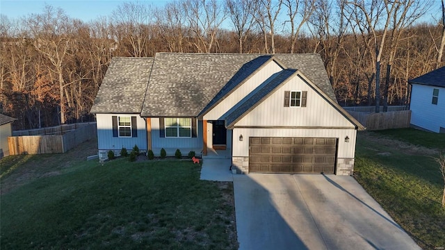 view of front of home featuring a porch, a garage, and a front lawn