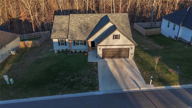 view of front of home featuring a front yard and a garage