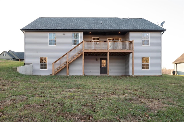 back of property featuring a lawn and a wooden deck