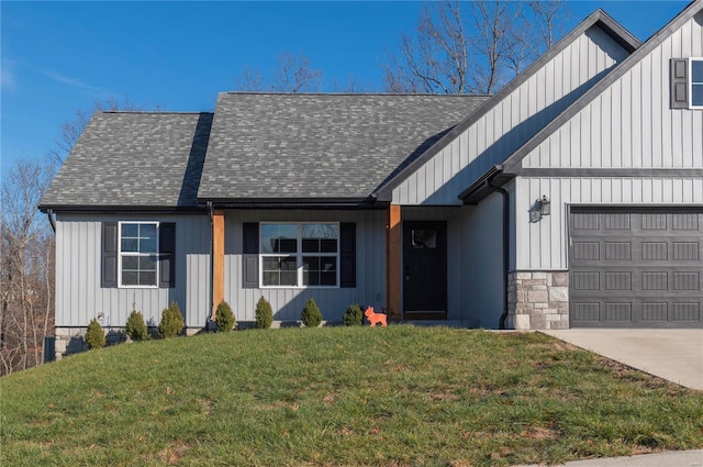 view of front of home with a front yard and a garage