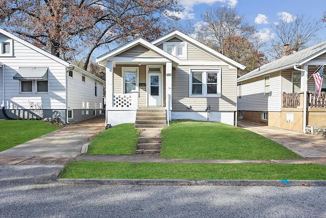 bungalow-style home with a front yard