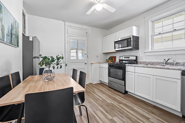 kitchen featuring sink, white cabinets, a healthy amount of sunlight, and appliances with stainless steel finishes