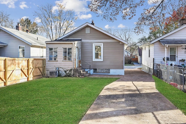 back of property featuring a lawn and central AC unit