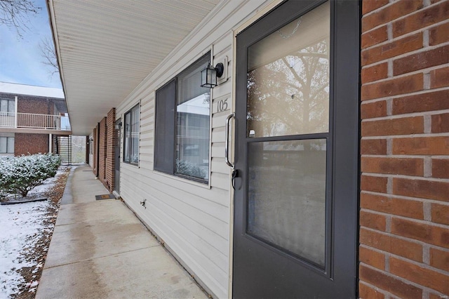 view of snow covered property entrance