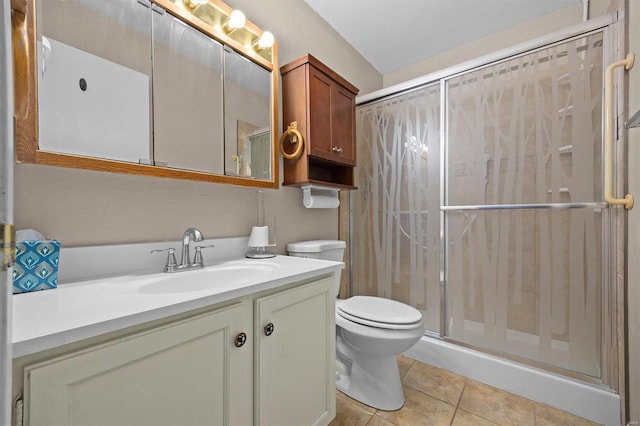 bathroom with a shower, tile patterned flooring, vanity, and toilet