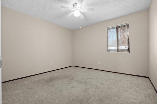 carpeted empty room with ceiling fan and a textured ceiling