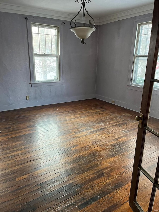 unfurnished dining area with dark hardwood / wood-style floors, plenty of natural light, and crown molding