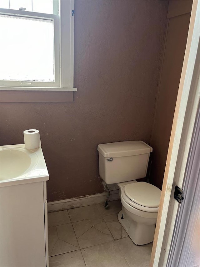 bathroom with tile patterned floors, vanity, and toilet