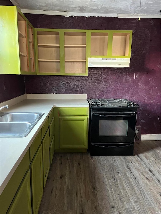 kitchen with electric range, green cabinets, sink, and hardwood / wood-style flooring