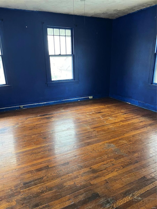 spare room with dark hardwood / wood-style flooring