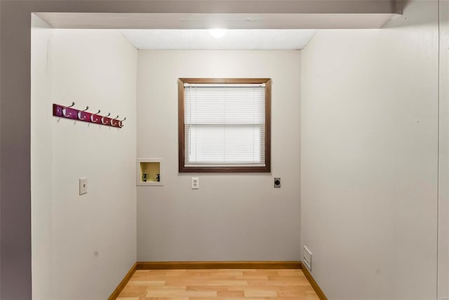 laundry room featuring hookup for an electric dryer, washer hookup, and light hardwood / wood-style floors