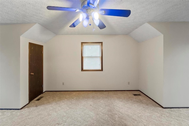 bonus room featuring ceiling fan, lofted ceiling, a textured ceiling, and light carpet