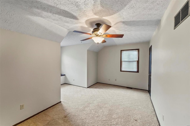 bonus room featuring ceiling fan, a textured ceiling, light carpet, and vaulted ceiling