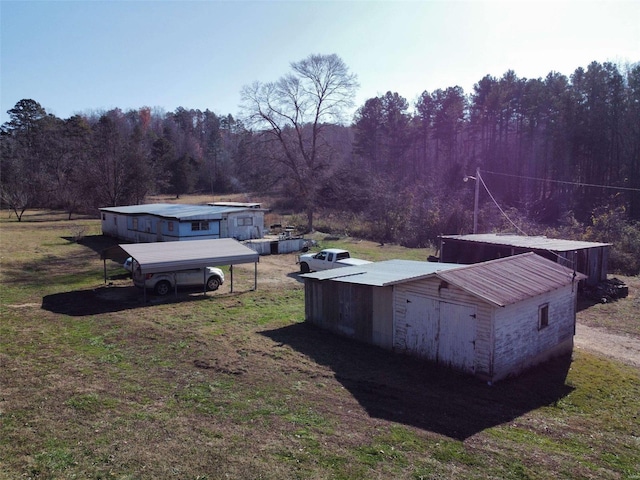 view of storm shelter with an outbuilding and a lawn