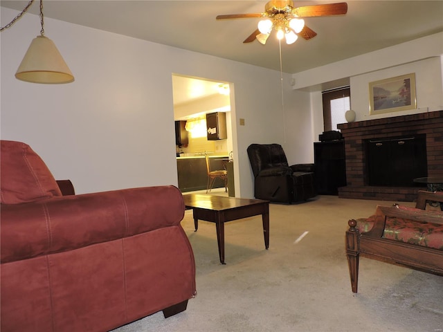 carpeted living room with a fireplace and ceiling fan