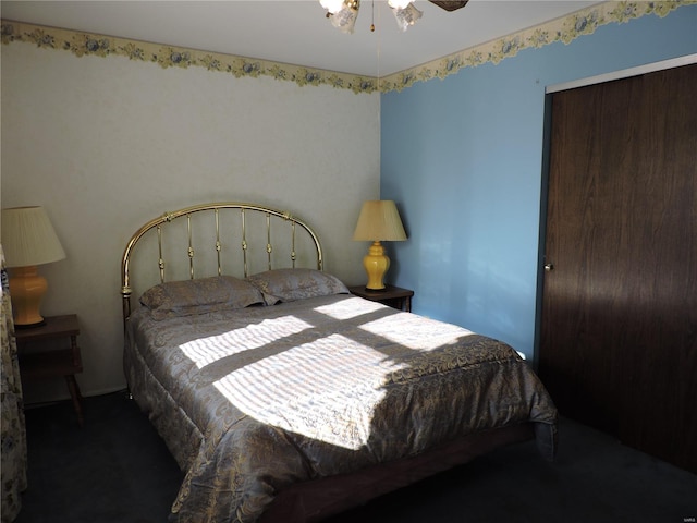 bedroom with ceiling fan and dark carpet