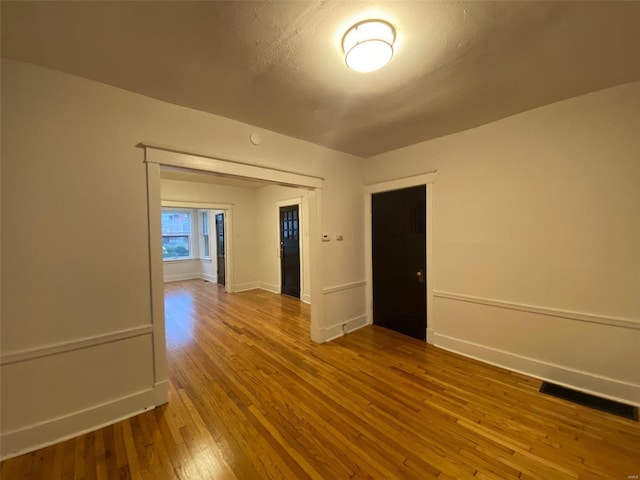 spare room with wood-type flooring