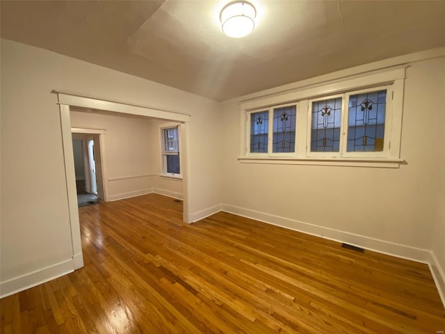 spare room featuring wood-type flooring