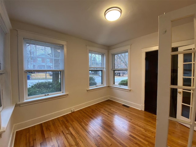 unfurnished room featuring hardwood / wood-style floors