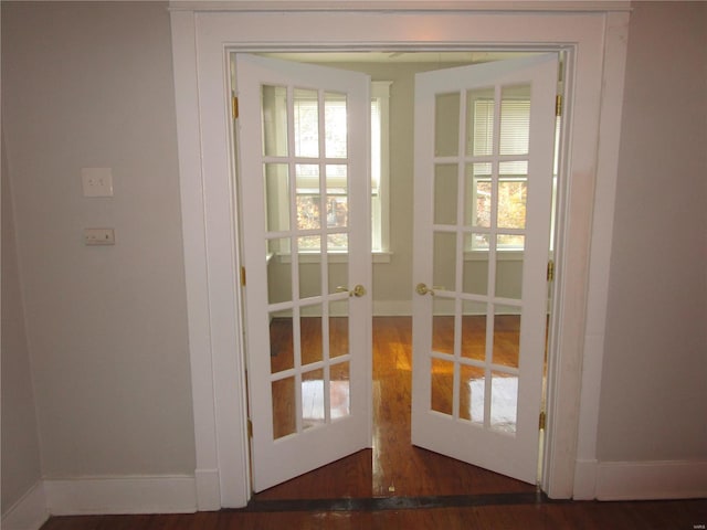 doorway with french doors and dark hardwood / wood-style floors