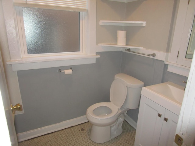 bathroom featuring tile patterned flooring, vanity, and toilet