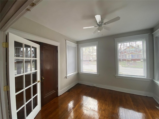 spare room featuring ceiling fan and dark hardwood / wood-style flooring