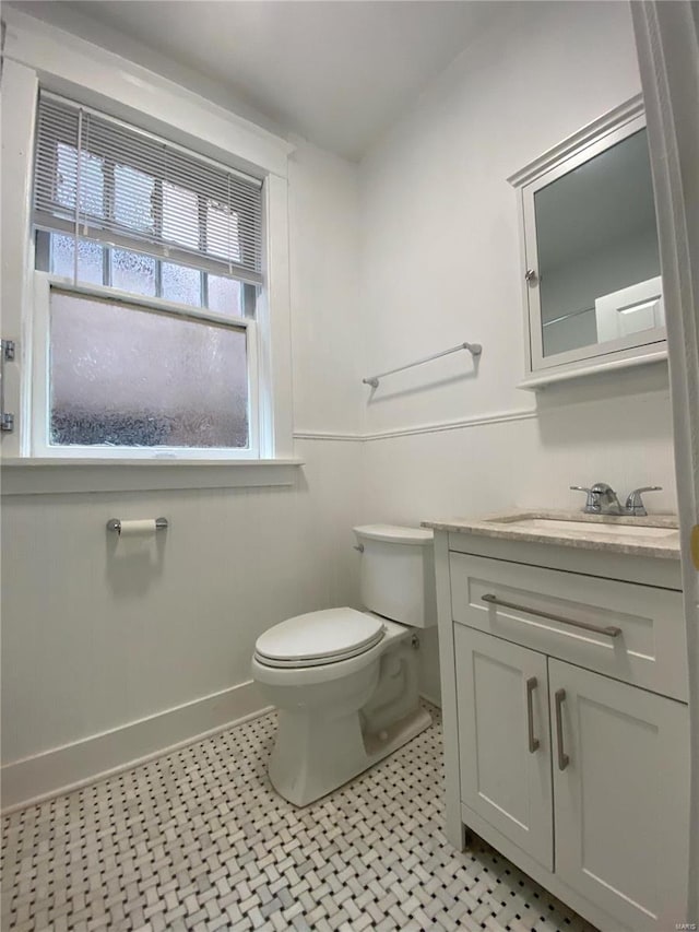 bathroom featuring tile patterned flooring, vanity, and toilet