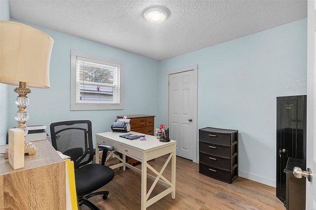 office space featuring light hardwood / wood-style floors and a textured ceiling