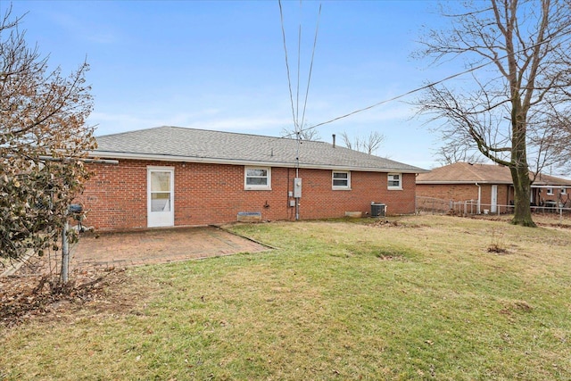 back of house with central AC, a patio area, and a lawn