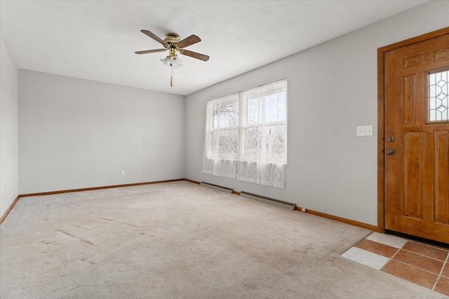 foyer entrance featuring light carpet and ceiling fan