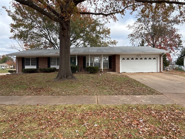 ranch-style home with a front lawn and a garage