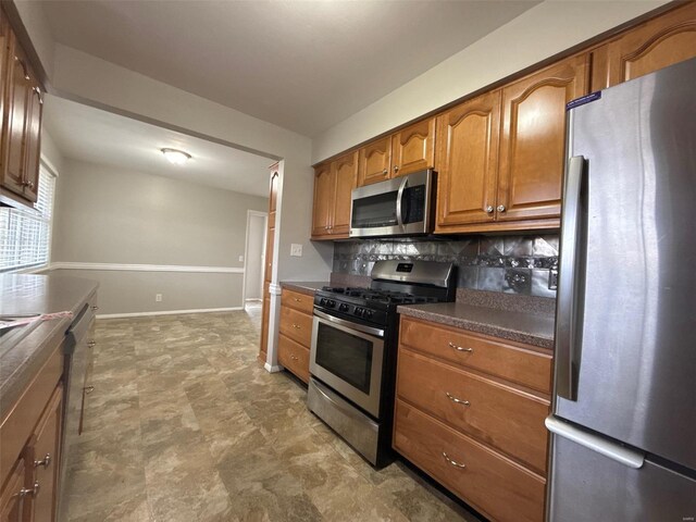 kitchen with backsplash and appliances with stainless steel finishes